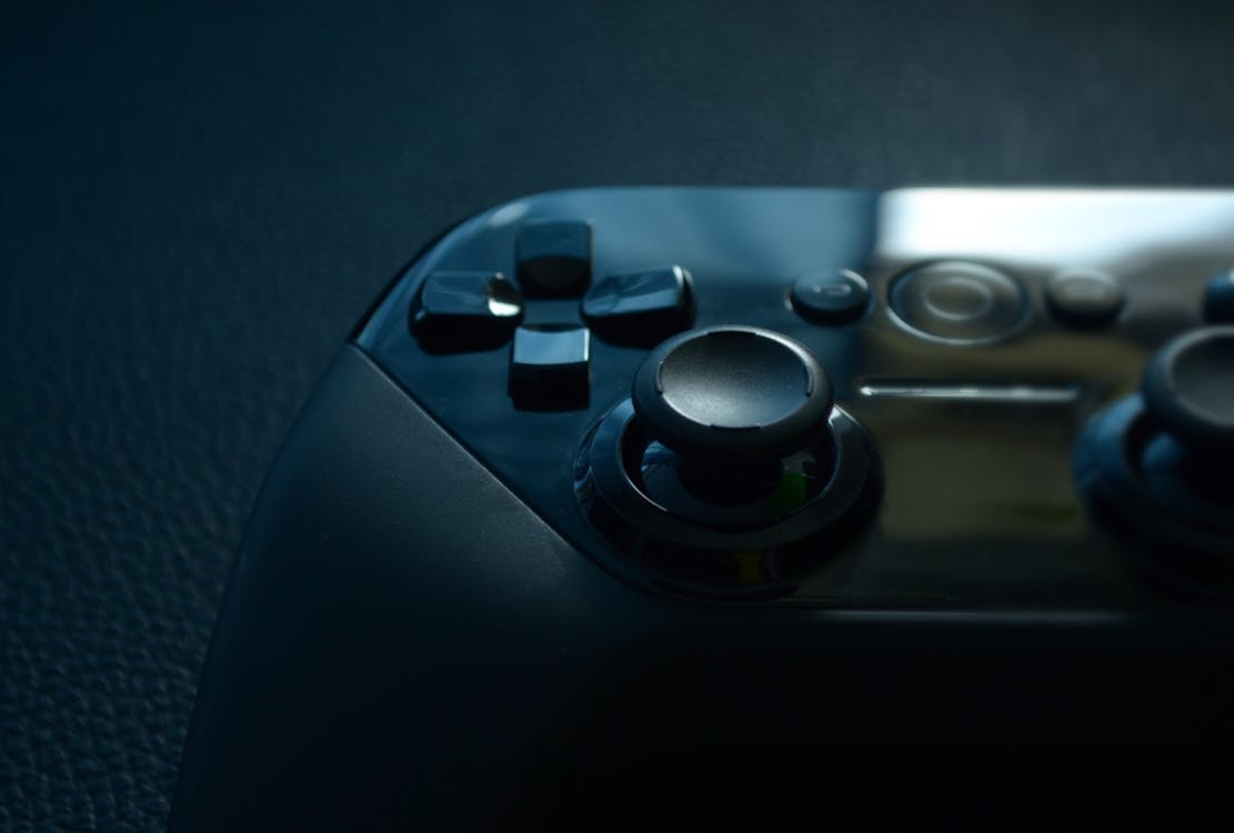 A close up of a game controllerAI-generated content may be incorrect.